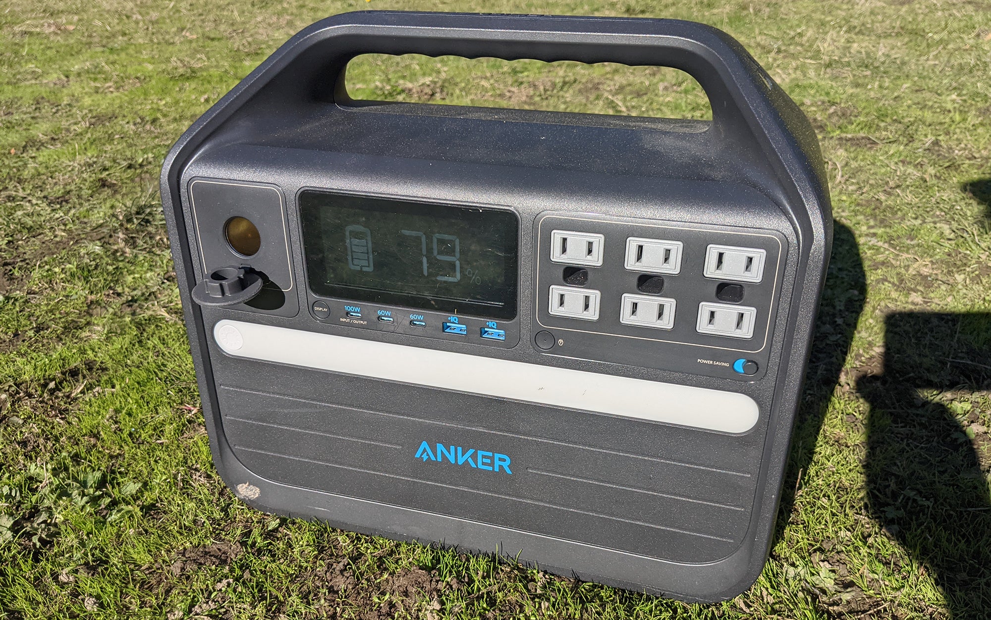 The Anker 555 sits in the grass.