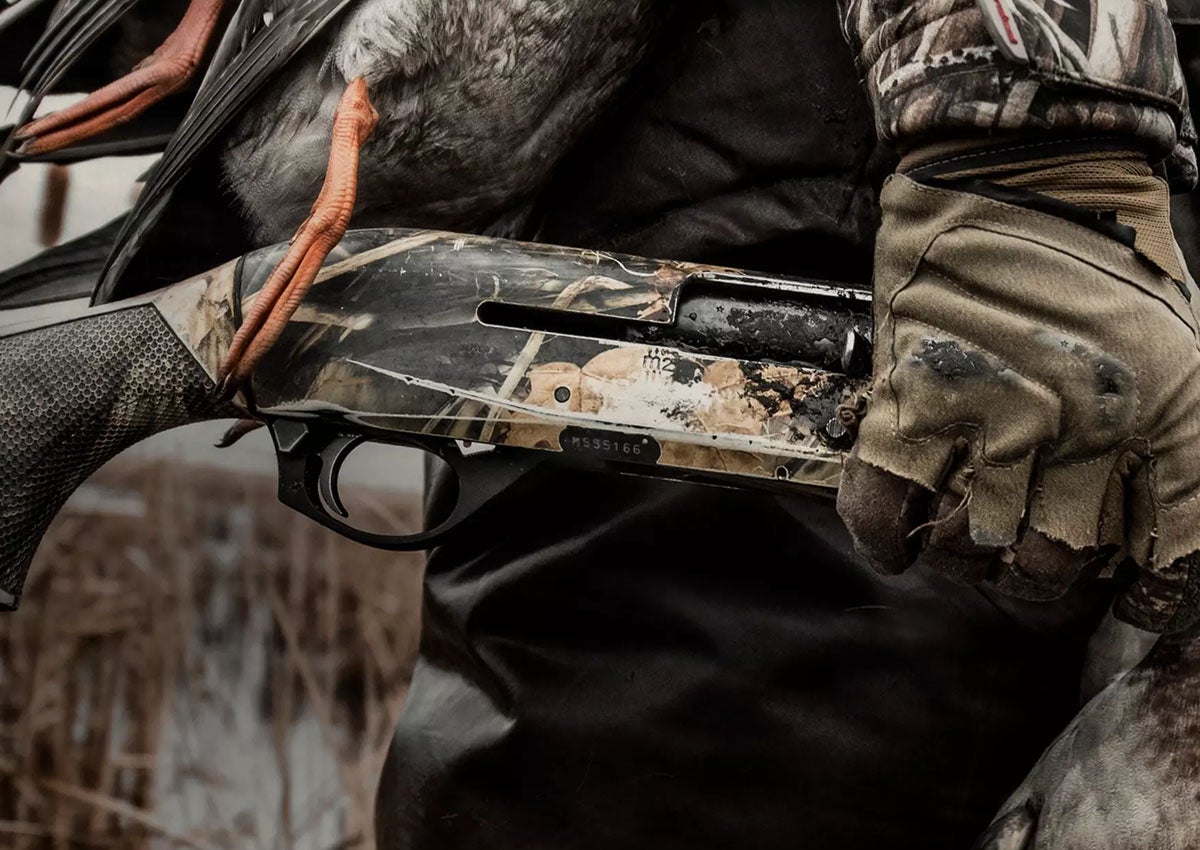 Duck hunter holds one of the best 20 gauge shotguns.